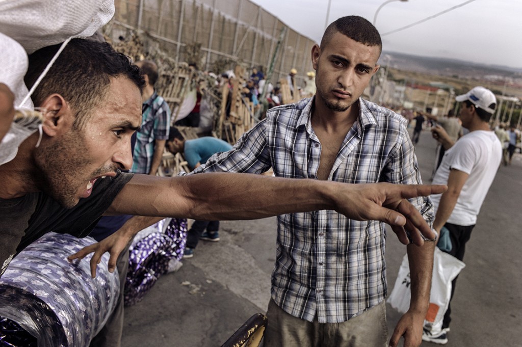Un joven que grita a la espera de cruzar el paso fronterizo Barrio Chino entre Melilla y Marruecos. Melilla, 29 de julio de 2015. José Colón.